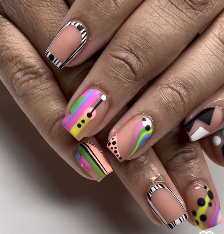 Short, colorful abstract shapes painted on fingernails